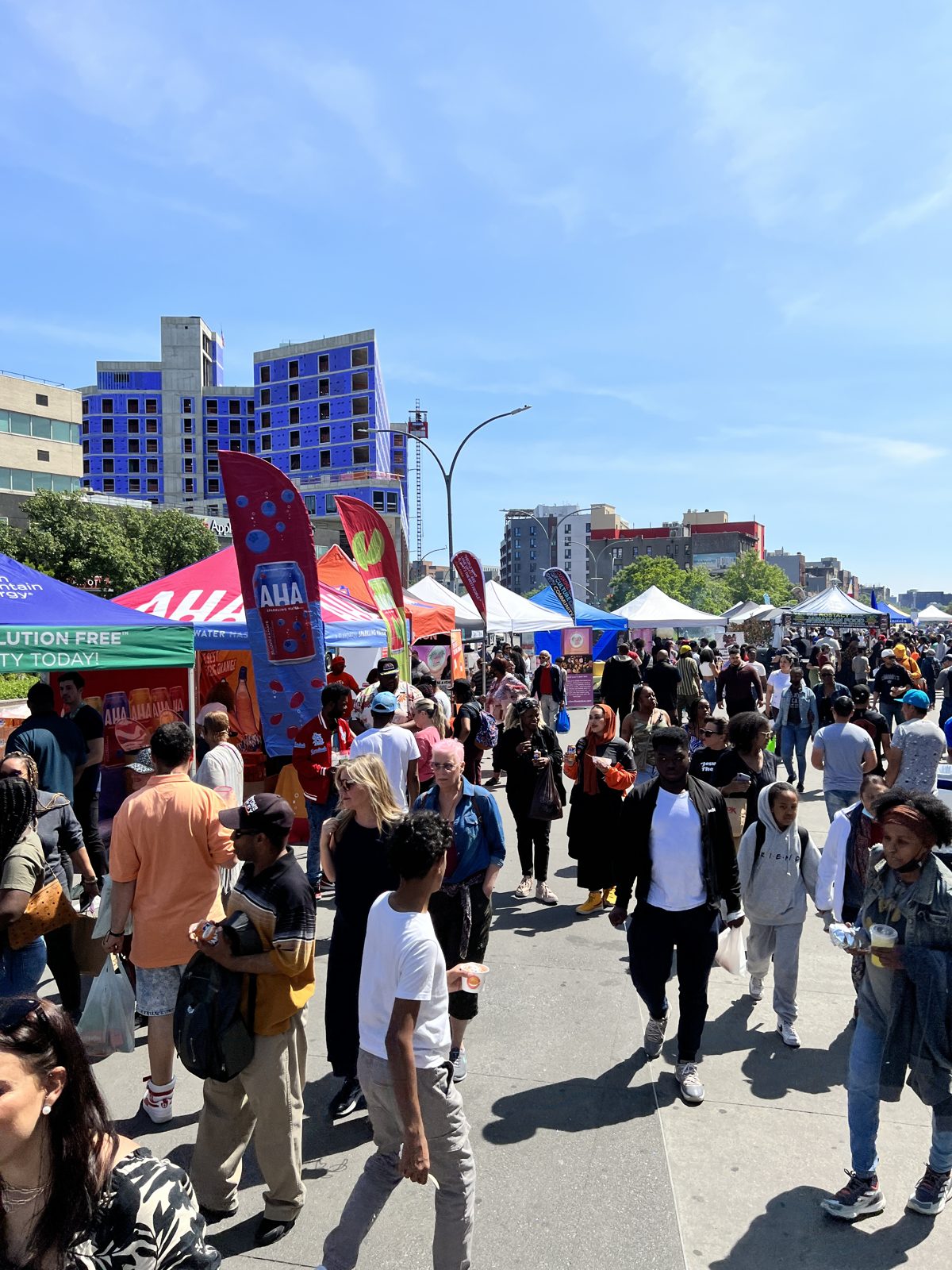 Bronx Night Market crowd in the sun at Grand Concourse