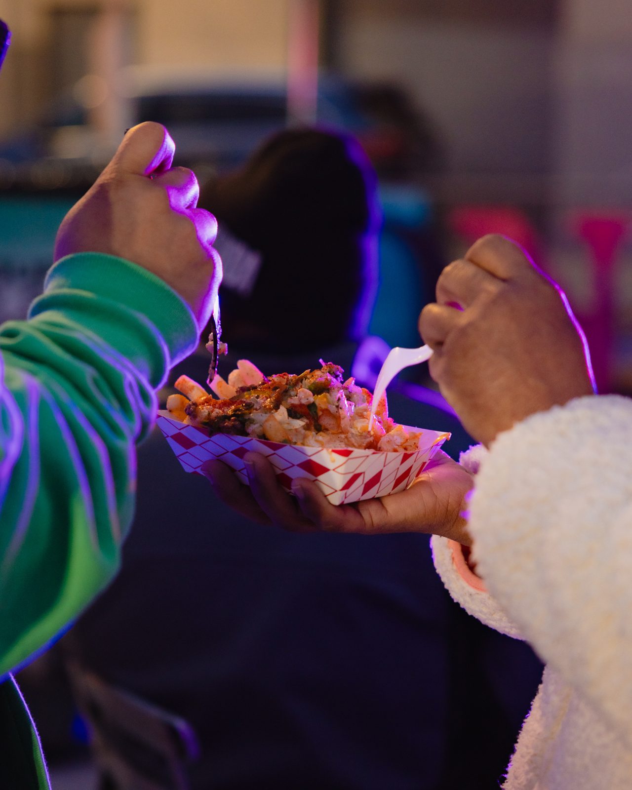 Loaded fries under neon night lights