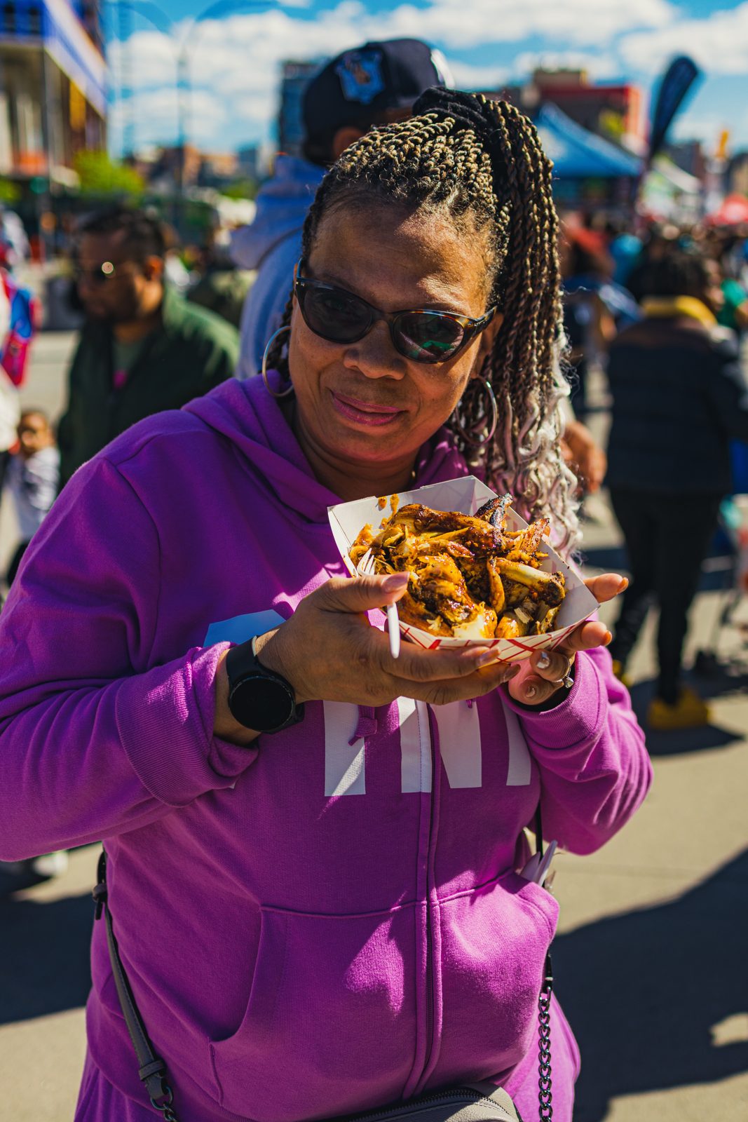 Attendee holding a basket of jerk wings