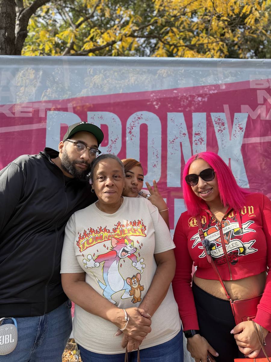 Friends in front of the Bronx Night Market banner, October 10 2026